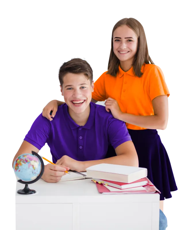A smiling student at a desk with books and a globe, a classmate standing behind him